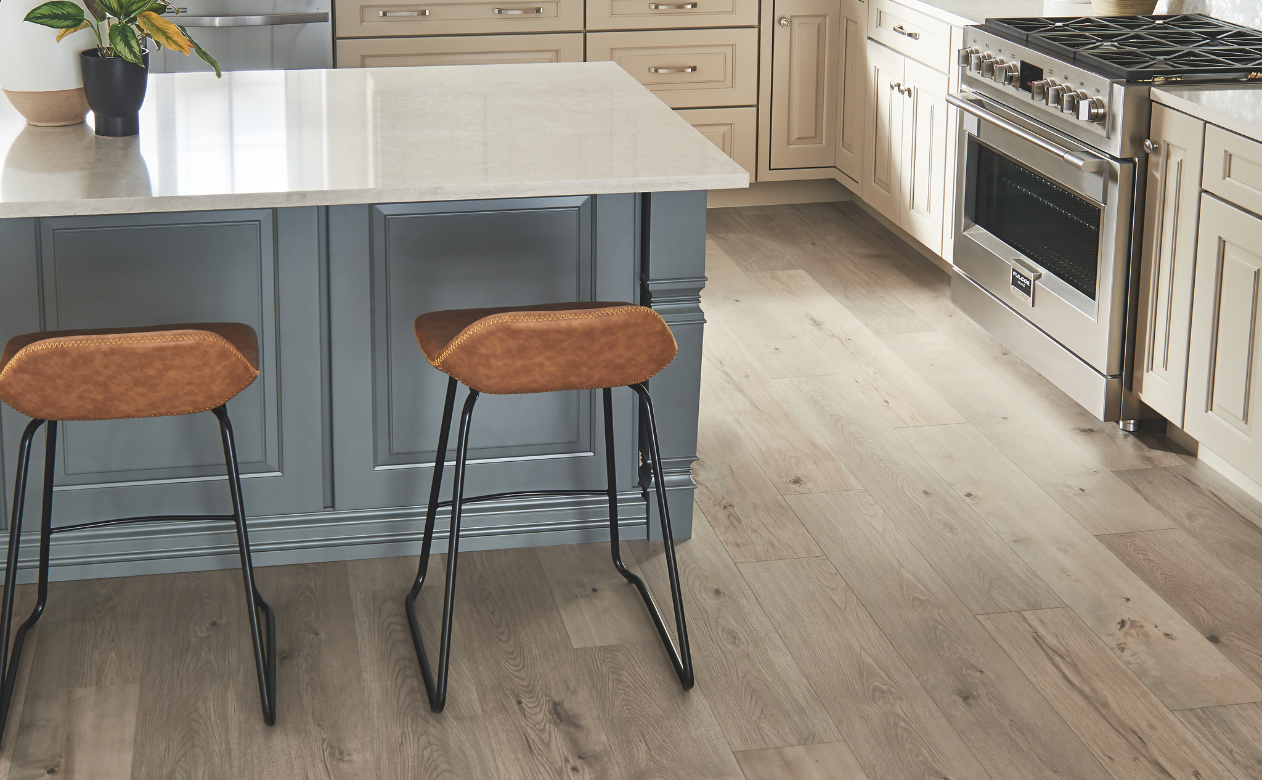 Laminate flooring in a kitchen with beige cabinetry
